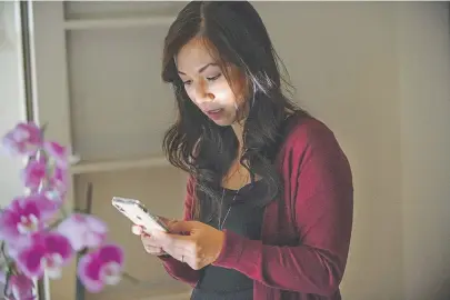  ?? Randall Benton, The Associated Press ?? Emergency room physician Dr. Anna Nguyen uses her smartphone to communicat­e with a remote patient from her Sacramento, Calif., home in August.