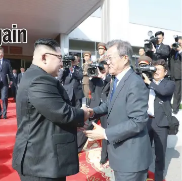  ?? — Reuters photo ?? South Korean President Moon Jae-in shakes hands with North Korean leader Kim Jong Un as he leaves after their summit at the truce village of Panmunjon.