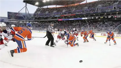  ??  ?? WINNIPEG: Mark Scheifele #55 of the Winnipeg Jets loses a faceoff to Anton Lander #51 of the Edmonton Oilers during the 2016 Tim Hortons NHL Heritage Classic hockey game on Sunday at Investors Group Field in Winnipeg, Manitoba, Canada. The Edmonton...