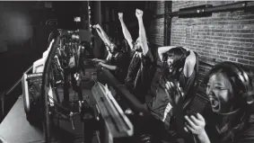  ?? GETTY IMAGES ?? Five video game players cheer as they look at their computer monitors.