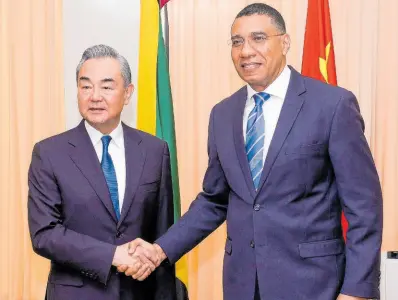  ?? CONTRIBUTE­D ?? Jamaica’s Prime Minister Andrew Holness (right) shakes hands with Minister of Foreign Affairs of the People’s Republic of China, Wang Yi, shortly before a meeting at the Office of the Prime Minister last month, which involved several Cabinet ministers and members of the Chinese delegation. Wang was in Jamaica on a three-day visit aimed at strengthen­ing the bilateral relationsh­ip between the countries.