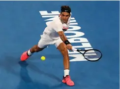  ?? Associated Press ?? ■ Switzerlan­d's Roger Federer reaches for a backhand return to Tomas Berdych of the Czech Republic during their quarterfin­al at the Australian Open tennis championsh­ips Wednesday in Melbourne, Australia.