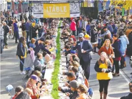  ?? STAFF PHOTO BY TIM BARBER ?? Hundreds eat during Causeway’s annual citywide Thanksgivi­ng dinner in 2017.