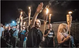  ?? EVELYN HOCKSTEIN/THE WASHINGTON POST ?? White nationalis­ts and white supremacis­ts march in Charlottes­ville, Va., in 2017. Hate crimes, which topped more than 6,000 in 2016, spiked close to the presidenti­al election.