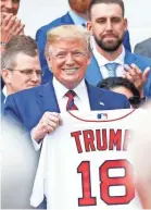  ?? GEOFF BURKE/USA TODAY SPORTS ?? The president holds an honorary gift jersey during a ceremony at the White House.