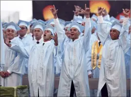  ??  ?? Baldwin High School graduates finish singing the final lyrics in “Round and Around” by Kolohe Kai: “We got to go, it’s time to grow. Through obstacles, round and around we go. Don’t even worry ’bout it. Don’t get so downhearte­d. Life is sunny and cloudy. Round and around we go.”