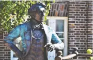  ?? DEREK BALDWIN / POSTMEDIA NEWS ?? The Holding Court statue of Canada's first Prime Minister Sir John A. Macdonald will remain on Main Street in Picton, Ont., after a 12-2 decision
by council to keep the artwork.