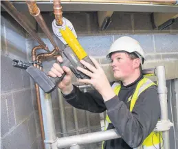  ??  ?? Plumbing apprentice Brad Mellor at work at Hafan Cefni.