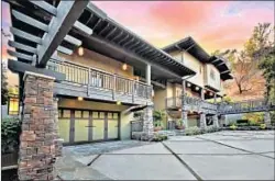  ??  ?? TAPERED STONE columns, a wide roof and deep eaves with rafter tails on Greinke’s home are typical of the Craftsman style.