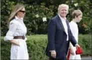  ?? THE ASSOCIATED PRESS ?? President Donald Trump, first lady Melania Trump, and their son and Barron Trump, walk to Marine One across the South Lawn of the White House in Washington on Saturday en route to Camp David in Maryland.