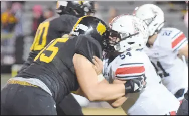  ?? RICK PECK/ SPECIAL TO MCDONALD COUNTY PRESS ?? McDonald County offensive lineman Kaidan Campbell (54) battles with all-state defensive lineman Jaiden Reibert of Cassville during the Wildcats’ 44-21 win on Oct. 23 at Cassville High School.