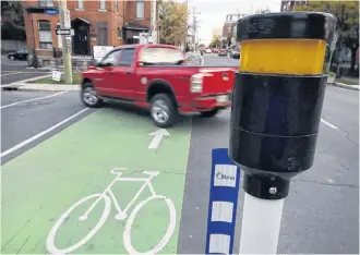  ?? TONY CALDWELL POSTMEDIA NEWS ■ ?? Ottawa may well need its painted bike lanes, but critics say smaller rural communitie­s have use for new roadways and sewer systems rather than energy-efficient projects or others related to transit.