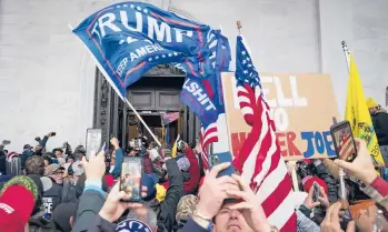  ?? JOHN MINCHILLO/AP ?? President Trump supporters take selfies, photos and videos last week at the Capitol in Washington.