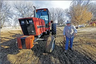  ?? (AP/Santa Fe New Mexican/Luis Sanchez Saturno) ?? Paul Skrak, owner of Hidalgo Farms in Pena Blanca, N.M., warms up his tractor Jan. 20 to prepare one of his fields for laser leveling. Skrak is adopting new growing methods to withstand drought.