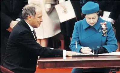  ?? funding. ?? Then-prime minister Pierre Trudeau watches the Queen sign the Charter of Rights and Freedoms in 1982. Columnist Licia Corbella says Trudeau’s son is ignoring tenets of the charter by forcing his government’s views on abortion on groups applying for...