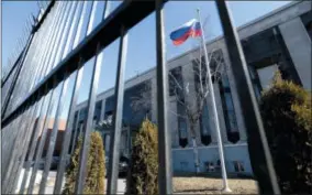  ?? JUSTIN TANG — THE CANADIAN PRESS VIA AP ?? A Russian flag flies outside the Embassy of the Russian Federation to Canada in Ottawa, Ontario, on Monday.