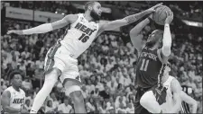  ?? WILFREDO LEE/AP PHOTO ?? Miami Heat forward Caleb Martin (16) blocks a shot from New York Knicks guard Jalen Brunson (11) during the first half of Game 3 of an NBA second-round playoff series on Saturday in Miami.