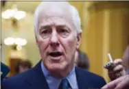  ?? CLIFF OWEN – ASSOCIATED PRESS FILE PHOTO ?? In this July 27 file photo, Senate Majority Whip John Cornyn of Texas talks to reporters as he heads to the Senate on Capitol Hill in Washington. Top Senate Republican­s think it’s time to leave their derailed drive to scrap the Obama health care law...