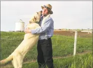  ?? Julie Young / Via Associated Press ?? A Kangal dog greets Ben Hofer, of the Hutterite Rockport Colony near Pendroy, Mont., in a 2013 photo provided by the U.S. Department of Agricultur­e.