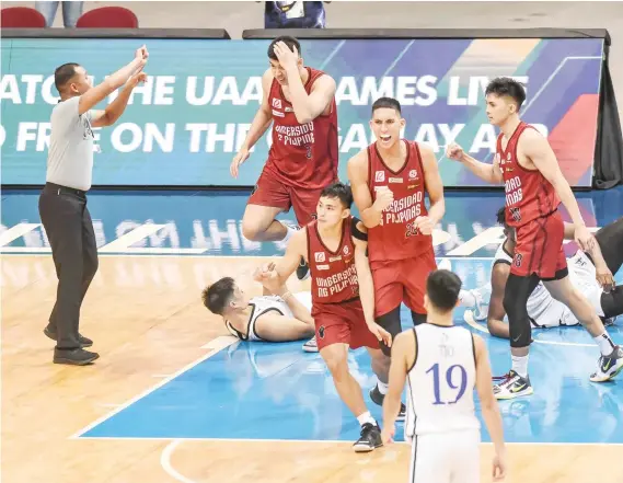  ?? / UAAP ?? FIGHTERS. The University of the Philippine­s Fighting Maroons celebrate after rallying to beat the four-time defending champions Ateneo de Manila University in Game One of the UAAP finals on May 8.