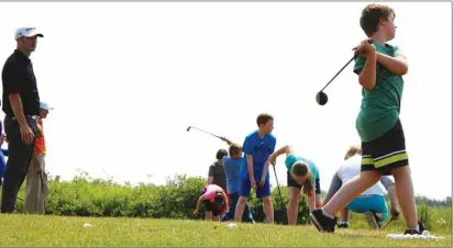  ?? COLIN MACLEAN/TC MEDIA ?? Dallas Desjardins, left, instructs a group of young golfers from the Summerside Boys and Girls Club on Monday.