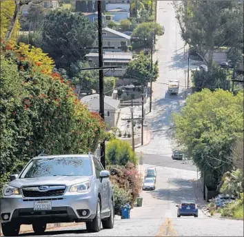  ?? Photograph­s by Marcus Yam Los Angeles Times ?? BAXTER STREET, L.A.’s third-steepest roadway, is the frequent scene of spinouts, confusion and crashes.
