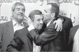  ?? Photograph­s by Ebrahim Noroozi Associated Press ?? FORMER IRANIAN President Mahmoud Ahmadineja­d, left, and ally Hamid Baghaei hug in Tehran after registerin­g for the presidenti­al election.