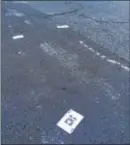  ?? DAVID FOSTER — THE TRENTONIAN ?? Playing cards litter the 500 block of Lamberton Street in Trenton where Kyronne ‘KD’ Hazel was gunned down on Thursday night.