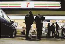  ?? AP PHOTO ?? SUDDEN VISIT: Immigratio­n and Customs Enforcemen­t agents serve an employment audit notice at a 7-Eleven convenienc­e store in Los Angeles yesterday.