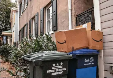  ?? Amanda Andrade-rhoades ?? Boxes sit on bins at a home in Washington's Georgetown neighborho­od. Consumers are being urged to recycle.