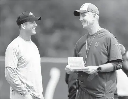  ?? MICHAEL CONROY/ASSOCIATED PRESS ?? Ravens coach John Harbaugh, left, talks with Colts coach Frank Reich during a joint practice at the Colts training facility Saturday. Reich, a Maryland graduate, helped lead the Eagles to their first Super Bowl title in February as Philadelph­ia’s offensive coordinato­r.