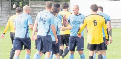  ?? Paul Watson ?? Joe Holt is congratula­ted by fellow Runcorn Town players following his successful second half spot-kick in the clash with Winsford United.