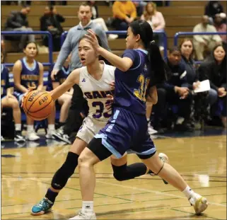 ?? PHOTO BY TRACEY ROMAN ?? Marina's Tiana To, right, puts pressure on Gahr's Christine Ho during Saturday night's CIF-SS Division 5AA semifinal. Ho sank a late 3-pointer to give the Gladiators a 39-38win and a berth in the title game.