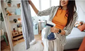  ?? Photograph: mixetto/Getty Images ?? A woman using a handheld steamer – these tend to be cheaper and better suited to travel.