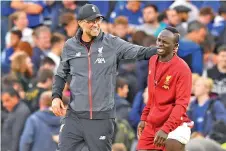  ??  ?? Jurgen Klopp (L) gestures to Sadio Mane (R) on the pitch after the English Premier League football match between Chelsea and Liverpool at Stamford Bridge in London last Sunday. - AFP photo