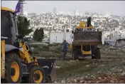  ?? MAYA ALLERUZZO — THE ASSOCIATED PRESS FILE ?? Workers take a break before European Union officials visit the constructi­on site for Givat Hamatos settlement in Jerusalem. Israel on Monday advanced plans to build 800 new settler homes in the occupied West Bank.