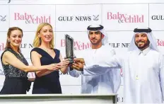  ?? Ahmad Ramzan/ Gulf News ?? Tabitha Barda (second from left), Editor, Baby &amp; Child, and Mehak Taneja (left), Relationsh­ip Manager, Gulf News, present the trophy to Salim Al Sabusi and Musabbeh Al Mheiri, after Kawasir won the Baby &amp; Child Trophy maiden.