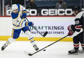  ?? Scott Taetsch/Getty Images ?? Buffalo’s Dylan Cozens, left, shoots in front of Washington’s Nicklas Backstrom in the third period of the Sabres’ 5-2 win Thursday in Washington, D.C.