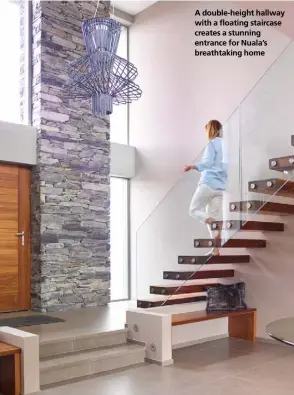  ??  ?? A double-height hallway with a floating staircase creates a stunning entrance for Nuala’s breathtaki­ng home