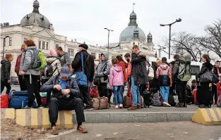  ?? ?? Fleeing Ukraine People wait for buses to take them out of Lviv