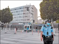  ?? GREG BAKER/GETTY-AFP ?? China will impose new restrictio­ns on U.S. diplomats. Above, a policeman patrols the U.S. embassy Saturday in Beijing.