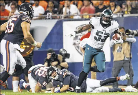  ?? GETTY IMAGES ?? Bears quarterbac­k Jay Cutler (6) watches as Eagles linebacker Nigel Bradham (53) takes off with Cutler’s fumble during Monday night’s game at Soldier Field in Chicago. Cutler aggravated a thumb injury on the play.