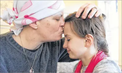  ?? MILLICENT MCKAY/JOURNAL PIONEER ?? Misty-Lynn Caseley gives her daughter, Charisma a peck on the forehead. Caseley was diagnosed with breast cancer earlier this year. Recently a benefit held in Caseley’s name has provided financial security for the Christmas season.