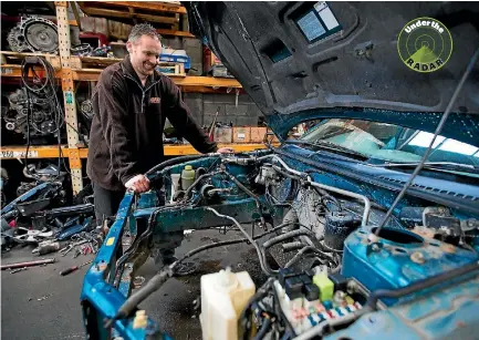  ?? PHOTO: MURRAY WILSON/STUFF ?? Abco parts salesman Quentin Barrow checks over the engine bay of an old Ford Laser.