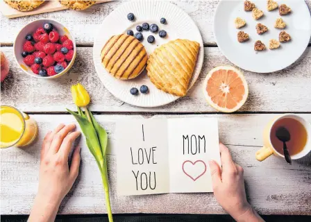  ?? STOCK IMAGE ?? Celebratin­g Mother’s Day with breakfast and a card.