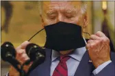  ?? PABLO MARTINEZ MONSIVAIS — THE ASSOCIATED PRESS ?? President Joe Biden removes his mask before speaking on the economy in the Roosevelt Room of the White House in Washington on Saturday.