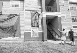  ?? JACOB LANGSTON/STAFF PHOTOGRAPH­ER ?? The building at Westbrook Apartments where a quadruple murder-suicide had occurred was left with broken windows, bullet holes and other damage.