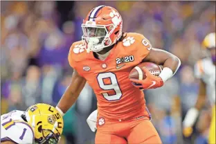  ?? Getty Images/tns - Kevin C. Cox ?? While Clemson quarterbac­k Trevor Lawrence has commanded much of the attention, running back Travis Etienne (above) got his chance to work out in front of NFL evaluators Thursday.