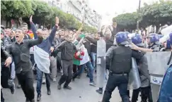  ?? PHOTO: ?? Security forces surround protesters in central Algiers
AFP