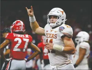  ?? The Associated Press ?? LONGHORNS BACK: Texas quarterbac­k Sam Ehlinger (11) celebrates his second touchdown carry in the first half of the Sugar Bowl Tuesday against Georgia in New Orleans.